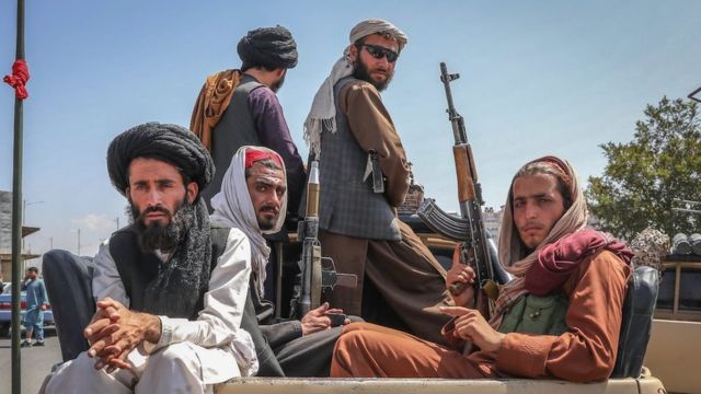 Taliban fighters are seen on the back of a vehicle in Kabul, Afghanistan, 16 August 2021.