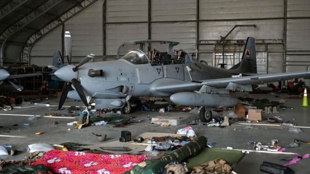 A-29 light attack aircraft surrounded by abandoned kit