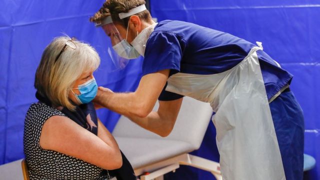 A woman receives a Covid vaccine at the Bournemouth International Centre