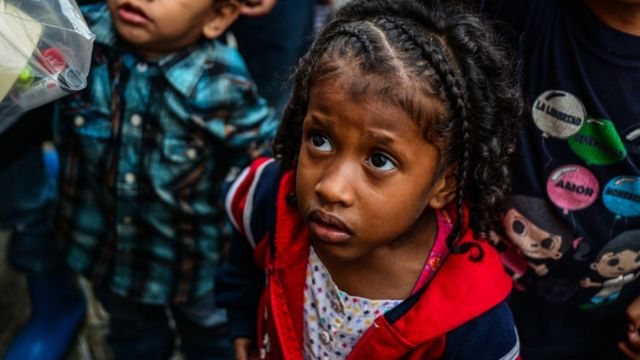 Children wait for food in soup kitchens that provides free food in Caracas on 5 November 2017