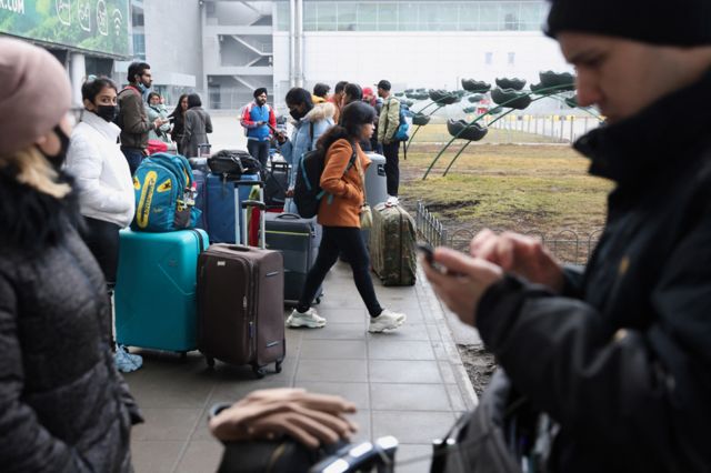 People wait at Kyiv Airport on 24 February 2022